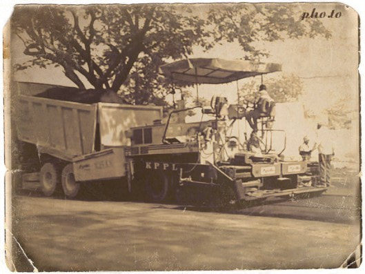 Machine laying hot asphalt on the road