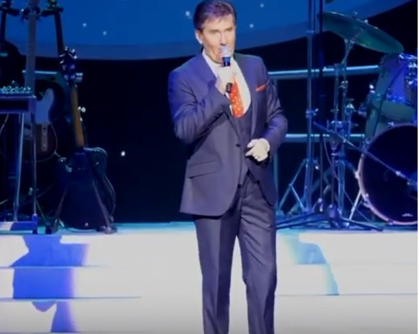 Daniel O'Donnell singing pretty little girl from Omagh on stage with his band