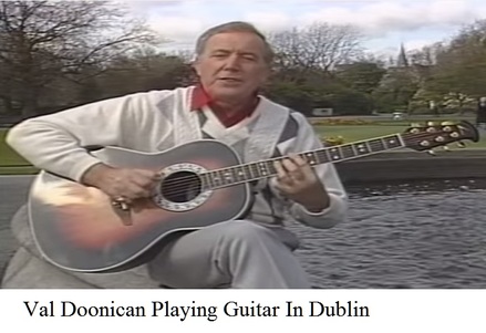 Val Doonican playing guitar