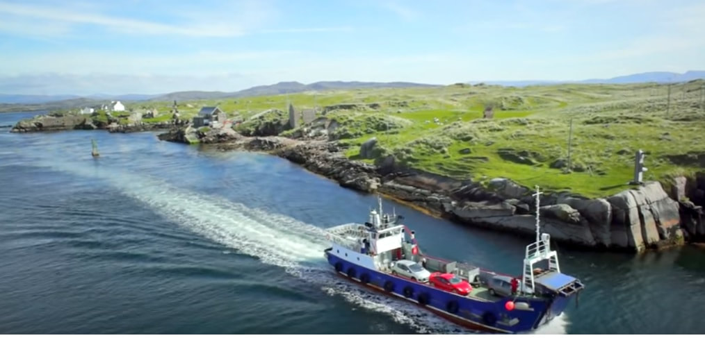 Donegal shore showing the coast line a car ferry and green fields