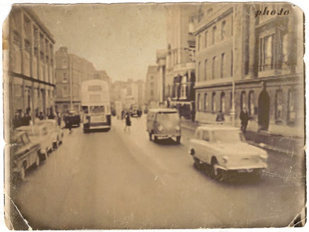 Old Dublin street showing shops and bus and cars