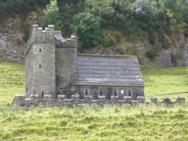 abandoned stone Church in Ireland surrounded by large stones and fields