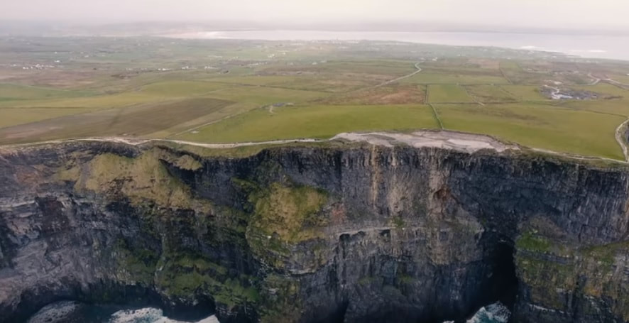 The Cliffs Of Moher Co Galway showing the rocky cliff and green fields